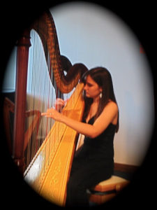 Emily playing the pedal harp.